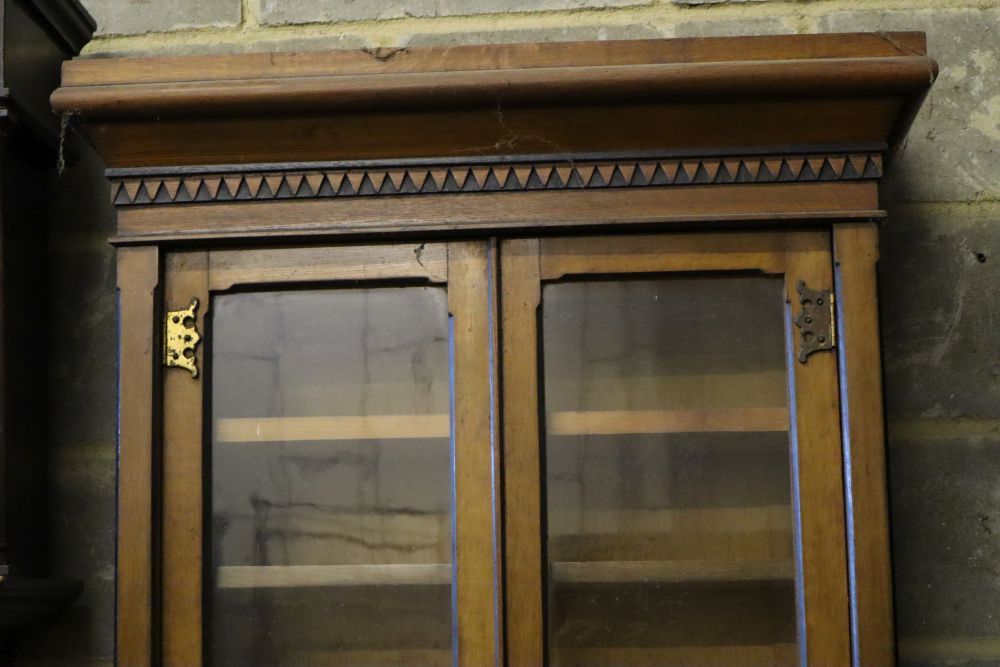 A late Victorian oak aesthetic movement bookcase cupboard, width 79cm depth 45cm height 216cm